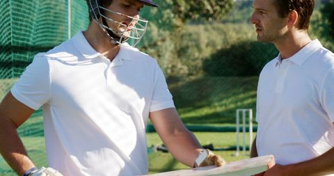 Cricket Players Discussing Batting Techniques During Practice - Download Free Stock Images Pikwizard.com