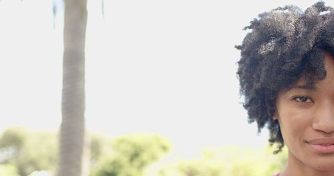 Young African American Female with Natural Hair Smiling Outdoors