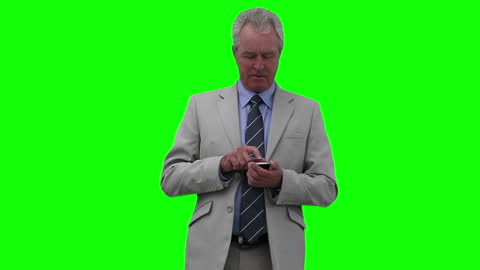 Elderly Businessman Typing on Smartphone against Green Screen
