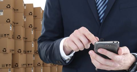 Businessman Using Smartphone for Logistics Management