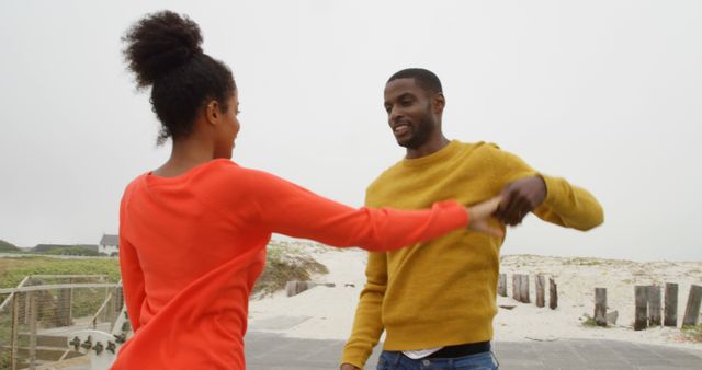 Joyful Young Couple Dancing on Beachfront - Download Free Stock Images Pikwizard.com