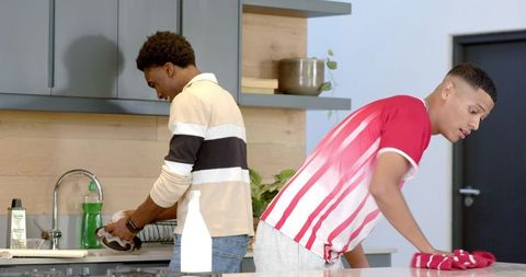 Diverse Friends Collaborating in Modern Kitchen Cleanup