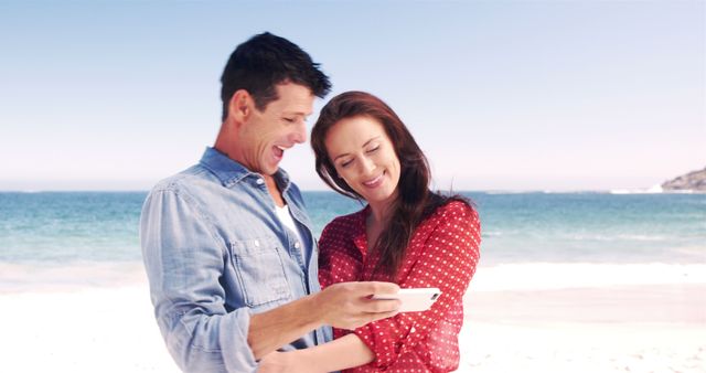 Smiling Couple Using Smartphone at Beach - Download Free Stock Images Pikwizard.com