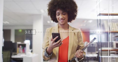 Smiling Woman Accessing Financial Data in Modern Office