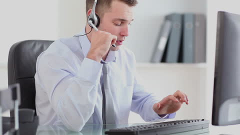 Professional Office Worker Engaging in Business Call with Headset