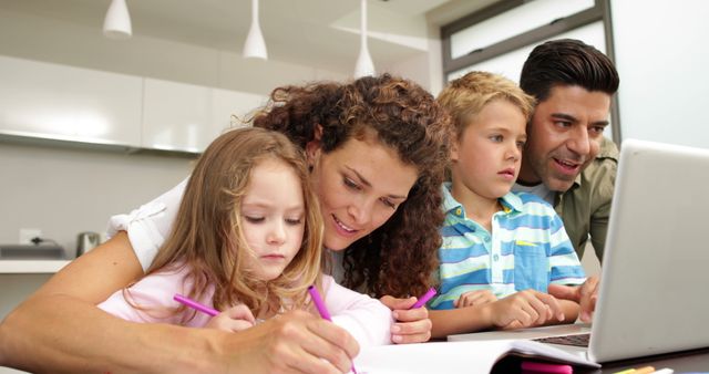 Happy Family Drawing and Using Laptop Together in Modern Kitchen - Download Free Stock Images Pikwizard.com