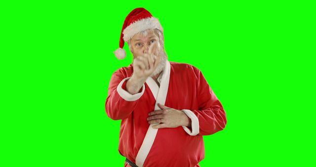 Santa Claus is wearing a traditional red costume with a white beard, pointing his finger as if conveying an important message or emphasizing something. The green screen background can be edited for various holiday-themed projects or greetings. Perfect for Christmas promotions, advertisements, banners, and seasonal digital content.