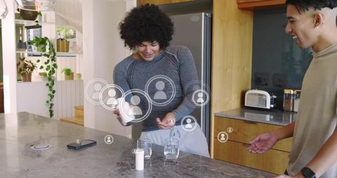 Mixing drink at kitchen island with augmented reality social avatars, friends interacting