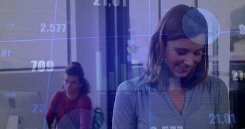 Businesswoman analysing data with overlay of financial charts