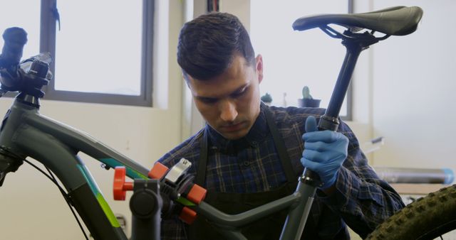 Male Bicycle Mechanic Adjusting Saddle in Workshop - Download Free Stock Images Pikwizard.com