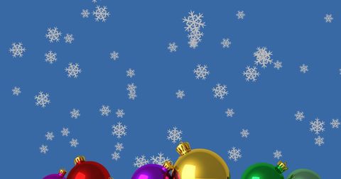 Falling Snowflakes Over Colorful Christmas Baubles on Blue Background