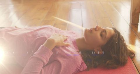 Woman Relaxing in Peaceful Sunlit Space with Hardwood Floor