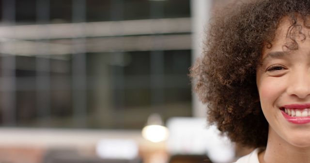 Smiling Woman with Curly Hair in Casual Office Environment - Download Free Stock Images Pikwizard.com