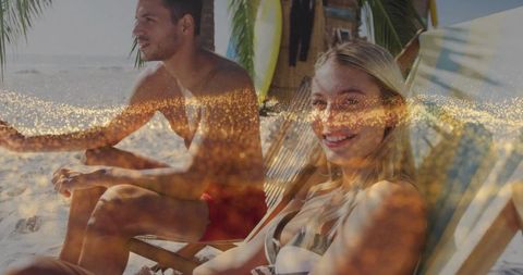 Couple Lounging on Tropical Beach Destination with Surfboards