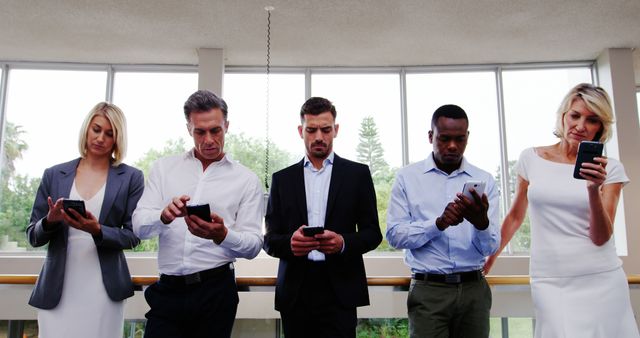 Group of Diverse Professionals Using Smartphones in Office Setting - Download Free Stock Images Pikwizard.com