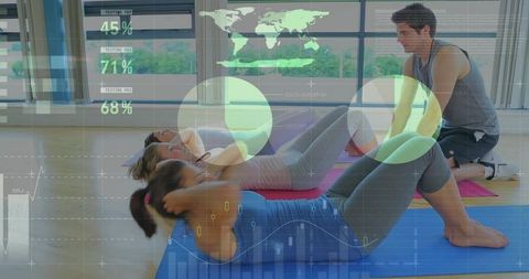 Group fitness class performing core crunches with trainer and digital fitness data overlay
