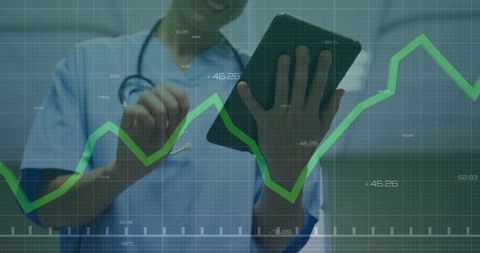 Clinician in Scrubs Using Tablet with Healthcare Analytics Graph