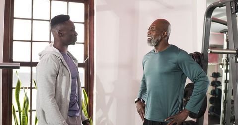 Two African American Men in Gym Discussing Fitness Goals