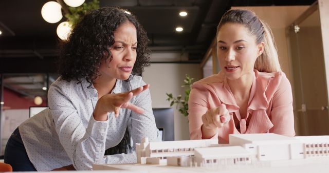 Two Female Architects Discussing Model in Office - Download Free Stock Images Pikwizard.com