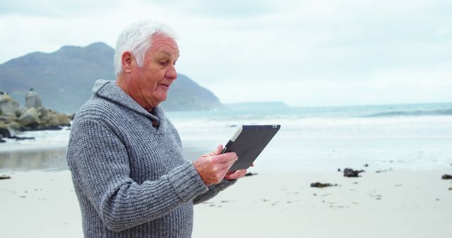 Senior Man Using Digital Tablet on Beach - Download Free Stock Images Pikwizard.com