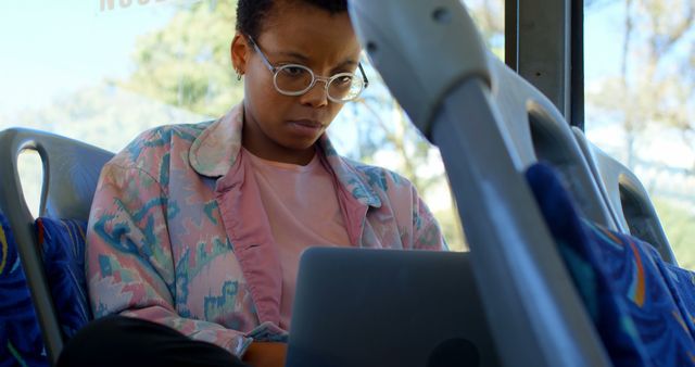 African american woman sitting in city bus using laptop - Download Free Stock Photos Pikwizard.com