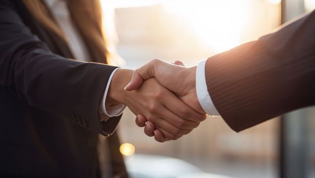 Executives shaking hands sealing partnership, building trust and collaboration in corporate deal