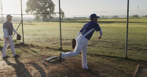 Pitcher Perfecting Throw Technique on Sunlit Field