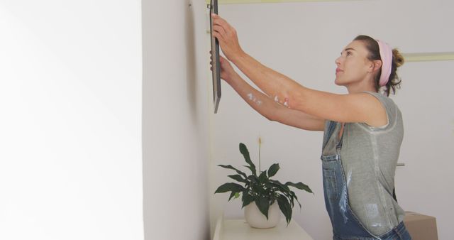 Woman Decorating Home with Hanging Frame - Download Free Stock Images Pikwizard.com