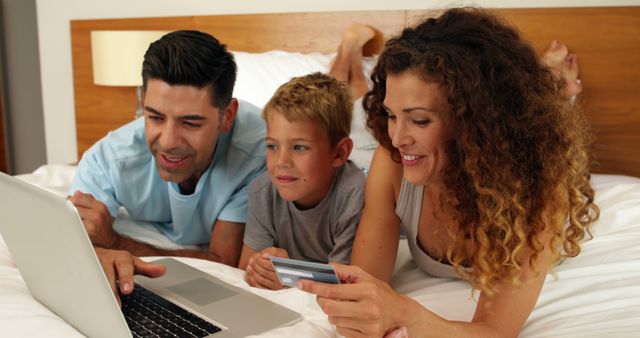 Family Online Shopping on Bed with Laptop and Credit Card - Download Free Stock Images Pikwizard.com