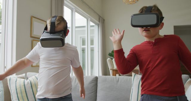 Caucasian boy with brother using vr headsets and standing in living room. family spending time at home.
