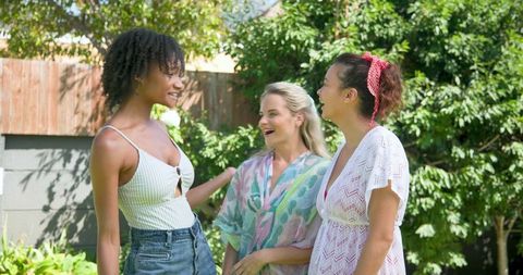 Diverse Female Friends Enjoying Conversation in Sunny Garden