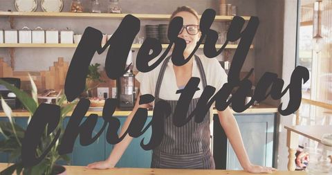 Festive Barista Wishing Merry Christmas at Cozy Coffee Shop