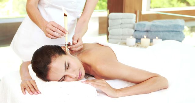 Woman Receiving Ear Candling Therapy at a Relaxing Spa - Download Free Stock Images Pikwizard.com