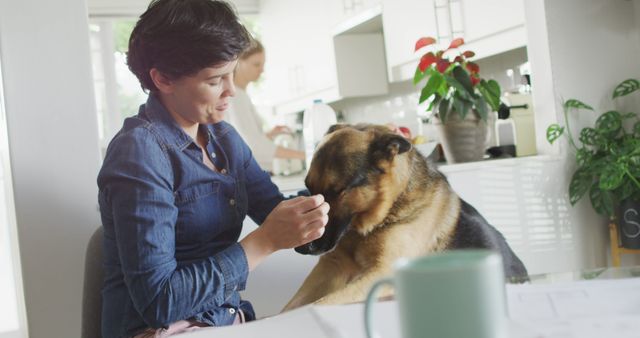 Caucasian woman playing her dog in the living room at home. pet love and care concept