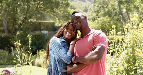 Happy Couple Embracing in Sunlit Garden