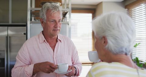 Senior Couple Enjoying Coffee Conversation at Home