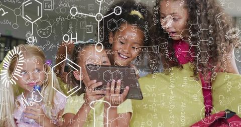 Girls exploring chemistry with smartphone and summer clothes, collaborative stem learning