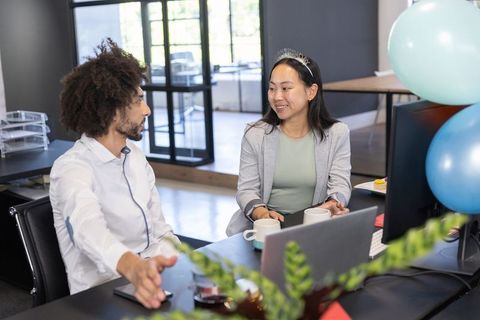 Diverse Coworkers Celebrating in Modern Office with Balloons