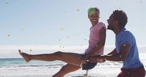 Joyful Couple Cycling on Beach with Smiles and Laughter