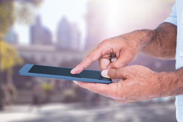 Composite image of hand holding digital tablet with city background 