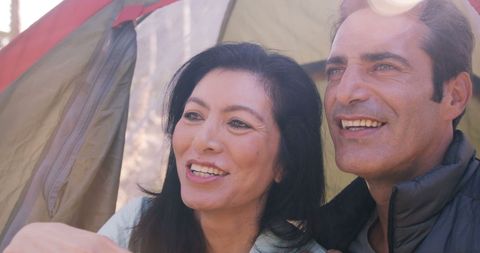 Smiling Couple Enjoying Camping in Forest Tent
