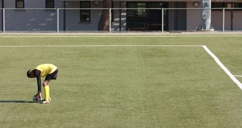 Youth Preparing for Soccer Kick on School Field