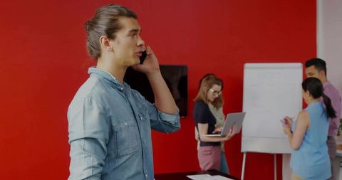 Young professional collaborating with team in modern office