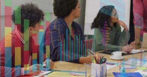 Creative Team Discussing Design with Digital Charts Overlay