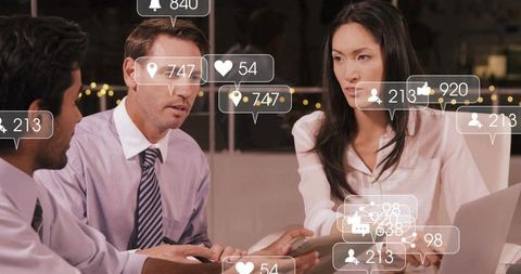 Professionals Analyzing Social Media Metrics in Modern Office