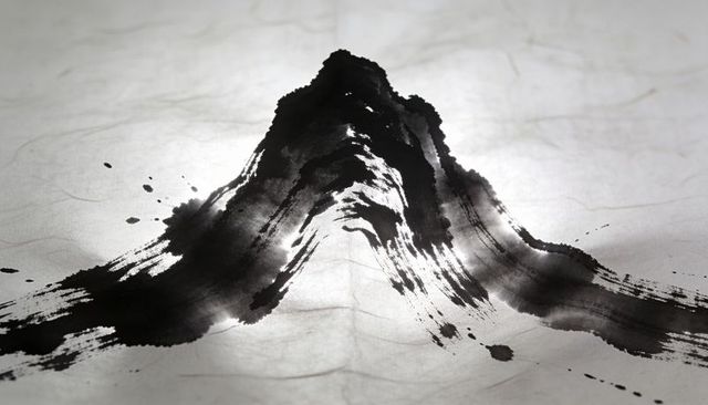 Monochrome sumi-e mountain brushstroke on textured paper with dramatic ink splatter