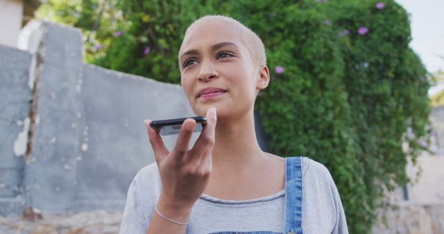 Young Woman with Short Hair Using Voice Command on Smartphone Outdoors - Download Free Stock Images Pikwizard.com