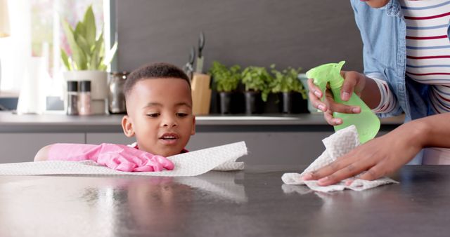 Mother and Young Son Cleaning Kitchen Counter Together - Download Free Stock Images Pikwizard.com