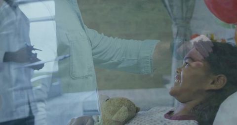 Happy child receiving care in hospital setting, medical professional examining