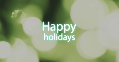 Merry holiday greeting over festive green lights